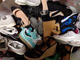 many pairs of shoes that are piled together on the floor