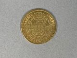 a gold coin with a coat of arms on it