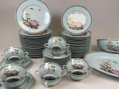 a lot of plates and cups and saucers on the table