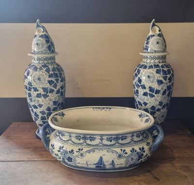 two blue and white vases and a bowl on a table