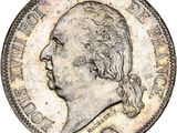 une pièce d'argent sur laquelle figure le portrait d'un homme de profil