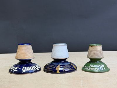 three small blue and green vases sitting on top of a wooden table