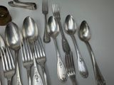 a lot of silver spoons and forks on the table