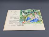 un livre ouvert sur lequel figure l'image d'un homme et d'une femme assis par terre