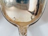 a silver spoon that is sitting on a table