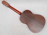 a close up of a wooden guitar on a white surface
