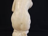 a white marble statue of a man with a hat on his head