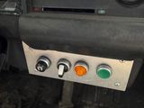 a close up of a car dashboard with a green light