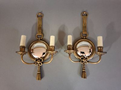 pair of antique brass wall sconces with mirrors and tassels