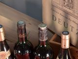 several bottles of wine are in a wooden box on a table