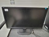 a computer monitor sitting on top of a desk next to a computer monitor