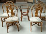 four chairs and a table with a glass top