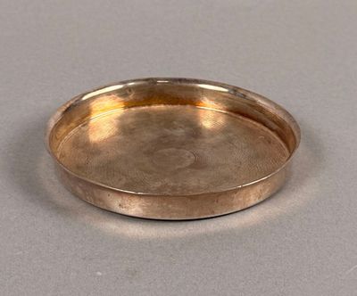 a silver plate on a table with a white background