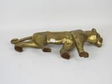 an antique brass lion figurine on a white background
