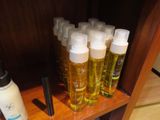 many bottles of lotion sitting on a wooden shelf