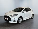 a white toyota yaris parked in a white room