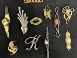 some gold and silver jewelry on a black surface