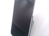 a cell phone that is sitting on top of a stand
