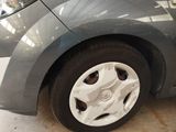 a close up of a car ' s tire on a tile floor