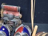 three masks and a hat sitting on a table
