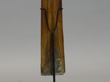 an image of a sculpture of a wooden cross on a metal stand