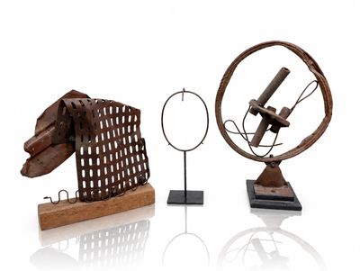 two sculptures of a horse and a wheel on a stand