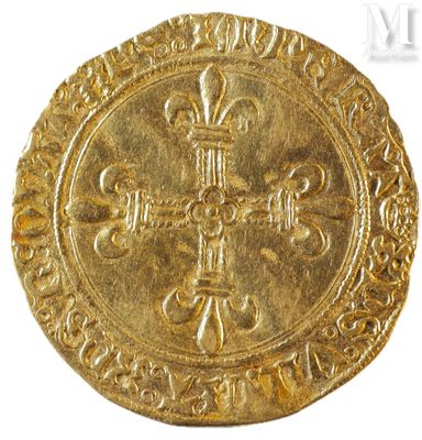 a gold coin with a cross and a crown on it
