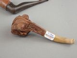 a pipe and a pipe holder sitting on a table
