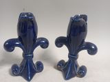 two blue vases that are sitting on a table