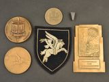 some coins and a medal are sitting on a table