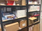 boxes are stacked on a shelf in a room with a refrigerator
