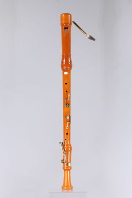 an orange flute on a white surface with a white background