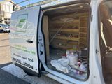 a white van with the door open on the side of the street