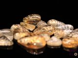 a pile of yellow and white rocks on a black surface