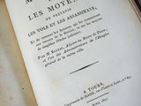 an old book open on a table with writing on it