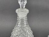 three glass decanters and a decanter on a table