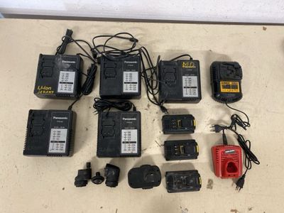 many different types of batteries and power cords laid out on a table