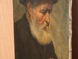 painting of an old man with a beard and a hat on a shelf