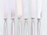 four knives are lined up in a row on top of each other