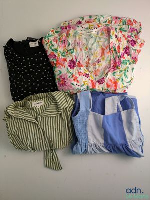 three shirts and shorts are laid out on a white surface