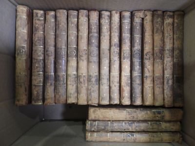 many old books in a box on the shelf