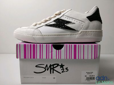 a pair of shoes that are on top of a box