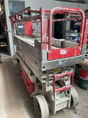 a red work truck parked in a garage