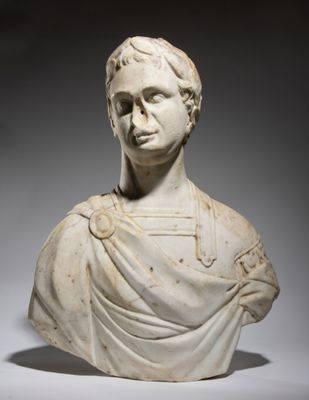 a white marble bust of a man wearing a cloak