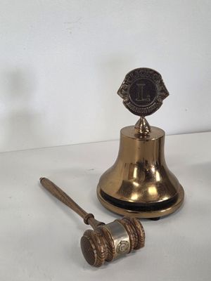 a bell and a hammer sitting on a table