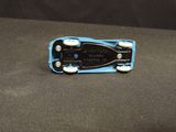 a small toy car that is sitting on a black surface