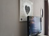 a flat screen tv sitting on top of a white dresser