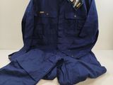 blue work suit sitting on top of a white table next to a lamp