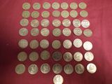 a lot of silver coins on a red cloth