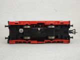 a red and black train engine on a white surface